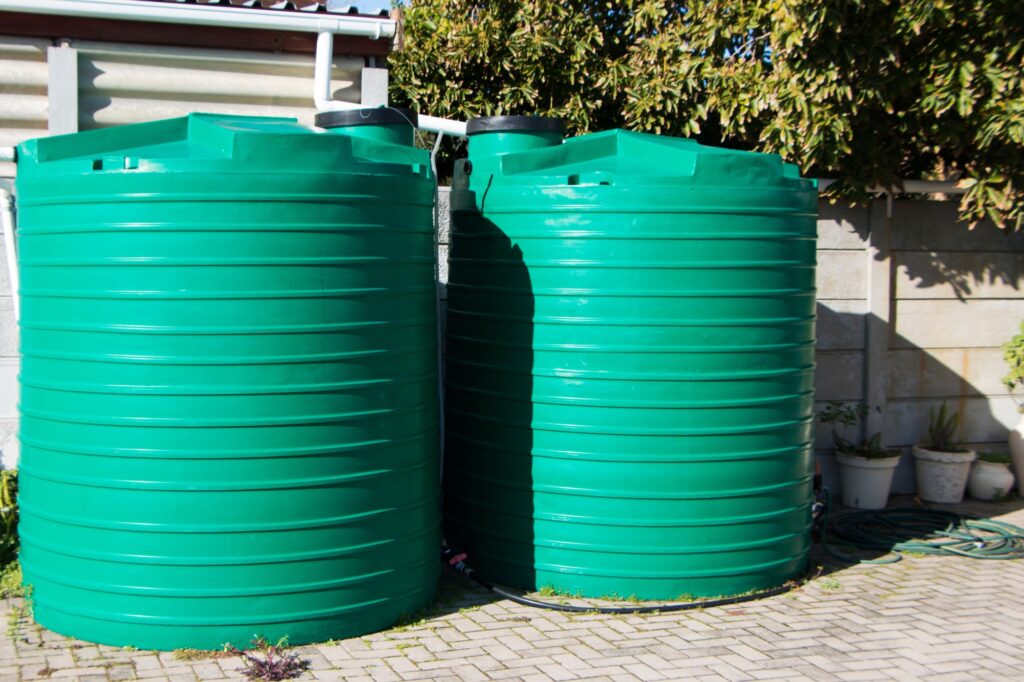 Water saving rain water catchment plastic tanks setup backyard pipes